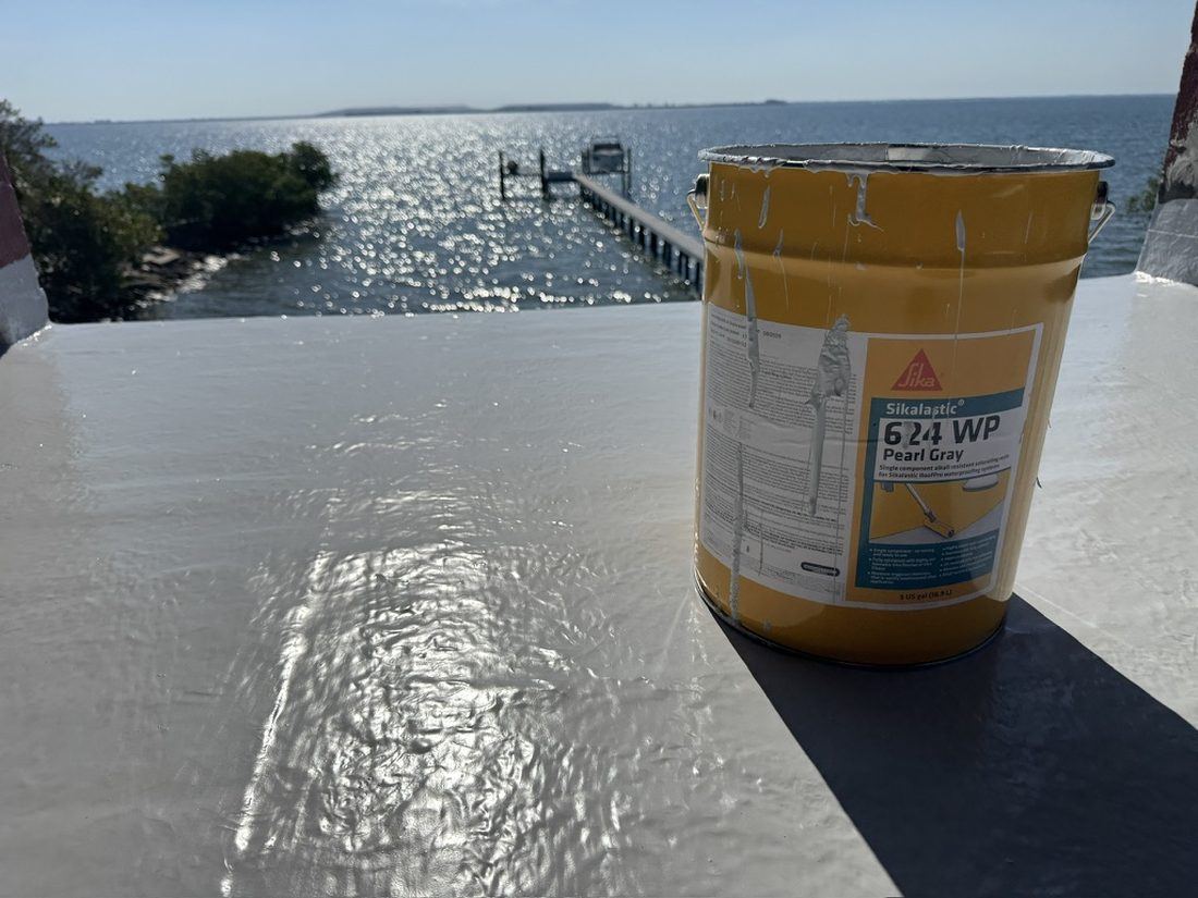 Waterproof deck coating in progress on a waterfront balcony